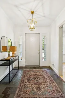 a view of a room with wooden floor cabinet and a window