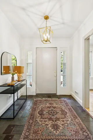 a view of a room with wooden floor cabinet and a window