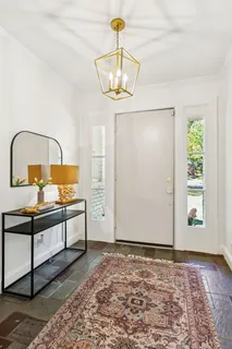a living room with furniture and a chandelier