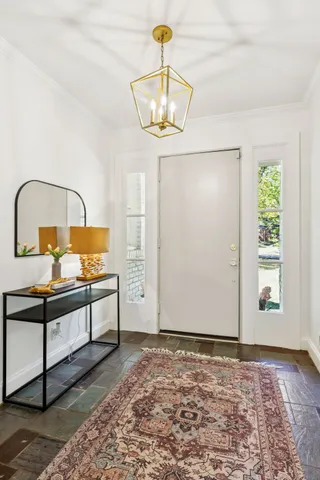 a living room with furniture and a chandelier
