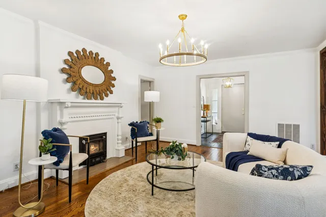 a living room with furniture and a chandelier