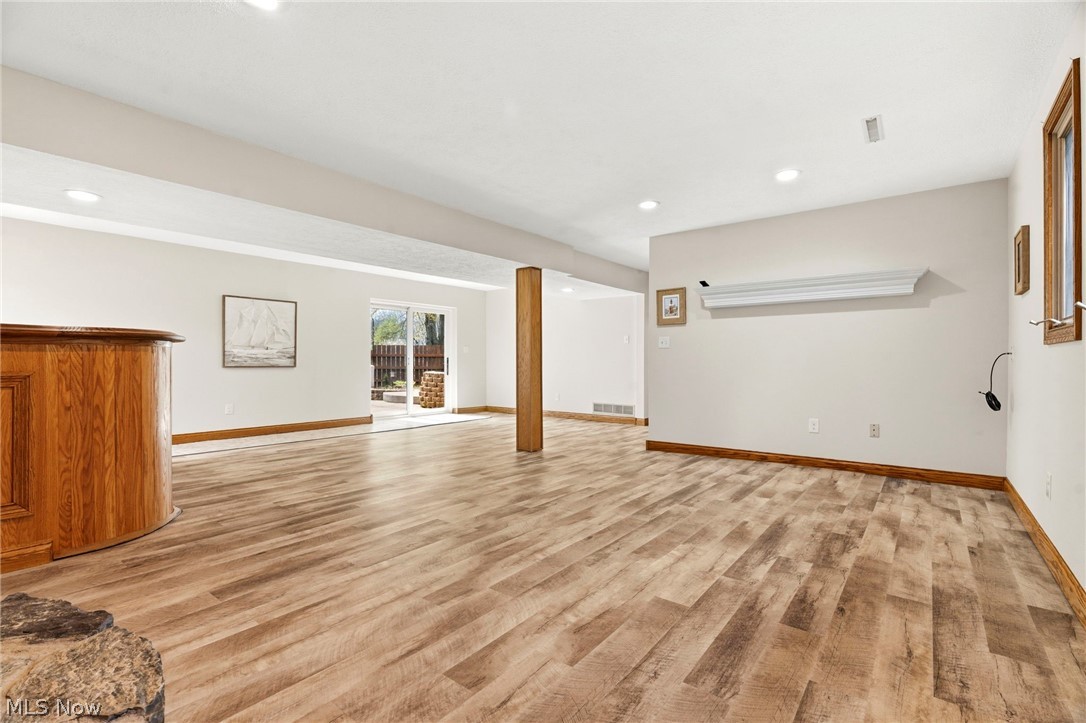 2400 Lancaster Road Akron, OH 44313 - Photo 28 of 41 This expansive room features light-toned walls, recessed lighting, wood-look flooring, and a sliding glass door leading to an outdoor area