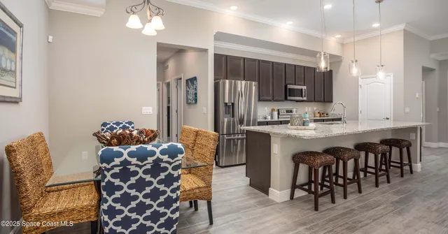 a kitchen with kitchen island a wooden floor and white cabinets