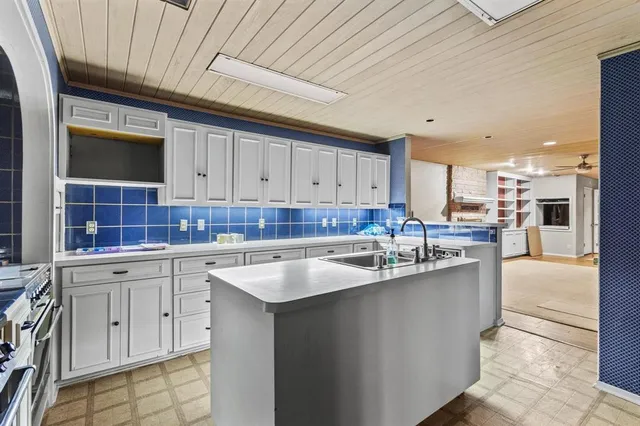 a kitchen with cabinets a sink and appliances