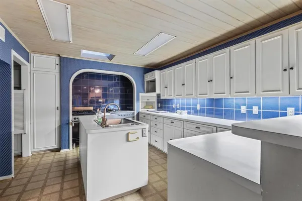 a kitchen with stainless steel appliances granite countertop a sink a stove and a refrigerator