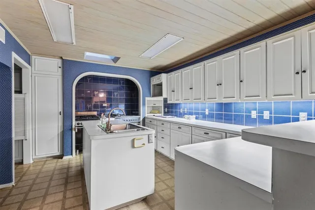 a kitchen with stainless steel appliances granite countertop a sink a stove and a refrigerator