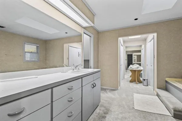 a spacious bathroom with a double vanity sink and a mirror