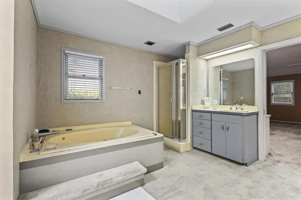 a bathroom with bathtub sink and mirror