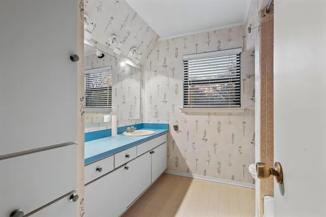 a bathroom with a tub sink and mirror