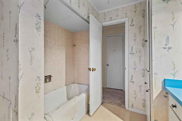 a bathroom with a bathtub and shower