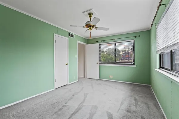 a view of a room with a window and a ceiling fan