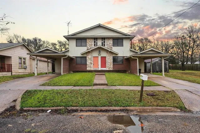 a front view of a house with a yard