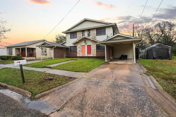 a front view of a house with a yard