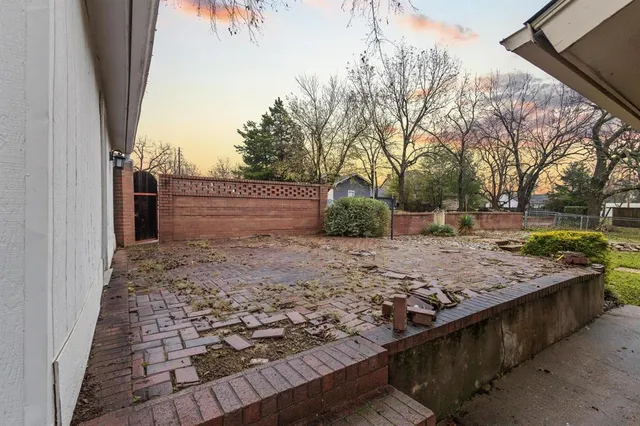 a view of a backyard with wooden fence
