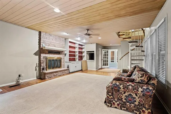 a living room with furniture a flat screen tv and fireplace