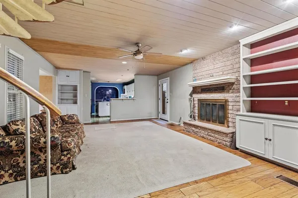 a view of an empty room with a fireplace