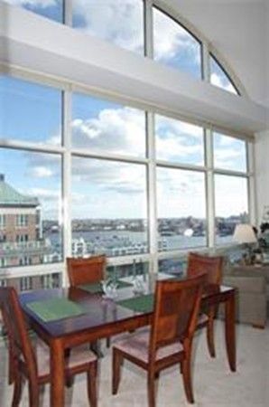 a view of a workspace with a table and chairs
