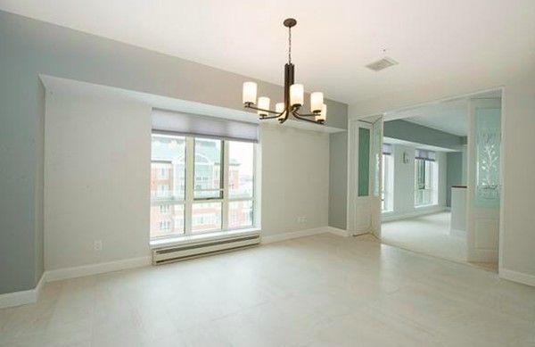 a view of a room with windows and chandelier