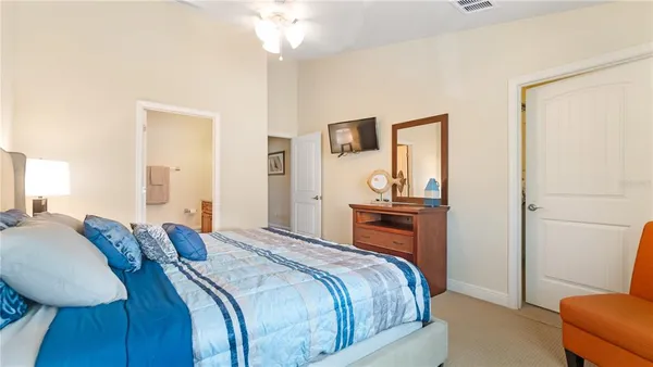 a bedroom with a bed and a dresser in it