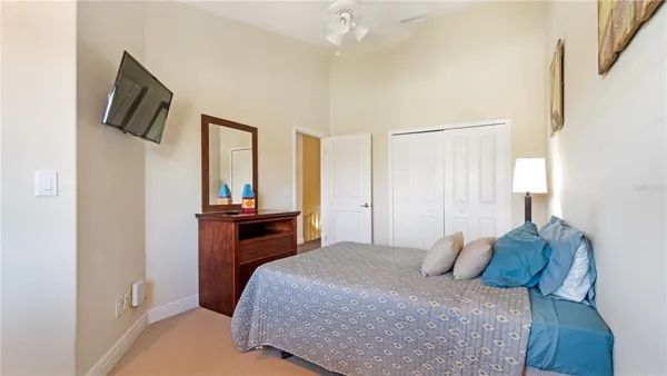 a bedroom with a bed and a television on table
