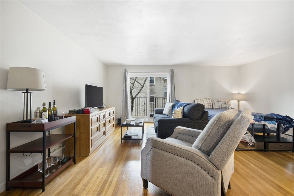 39 Englewood Avenue, Unit 17 Boston, MA 02135 - Photo 1 of 14 a living room with furniture and a flat screen tv