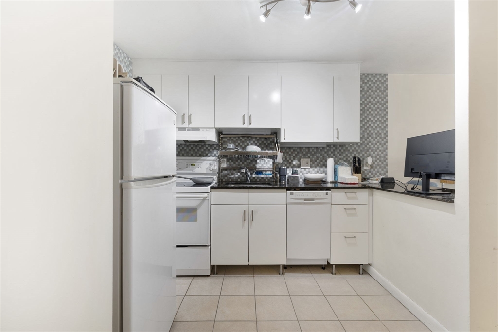 39 Englewood Avenue, Unit 17 Boston, MA 02135 - Photo 6 of 14 a kitchen with a white cabinets and white appliances