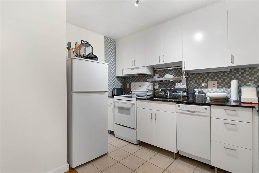39 Englewood Avenue, Unit 17 Boston, MA 02135 - Photo 7 of 14 a kitchen with granite countertop white cabinets and white appliances