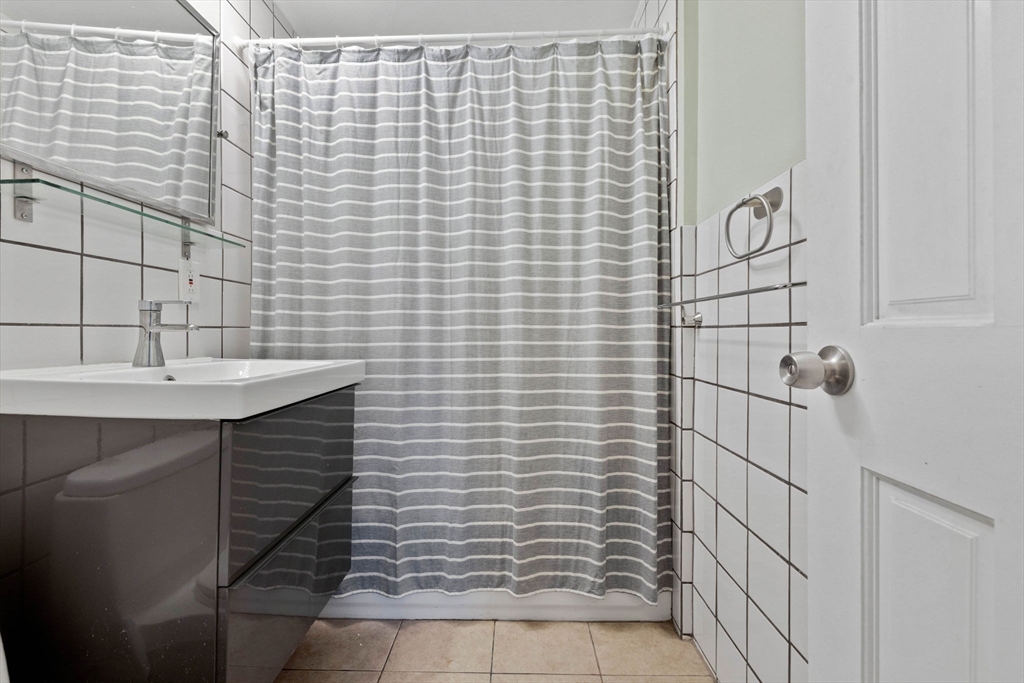 39 Englewood Avenue, Unit 17 Boston, MA 02135 - Photo 10 of 14 a bathroom with a sink and shower