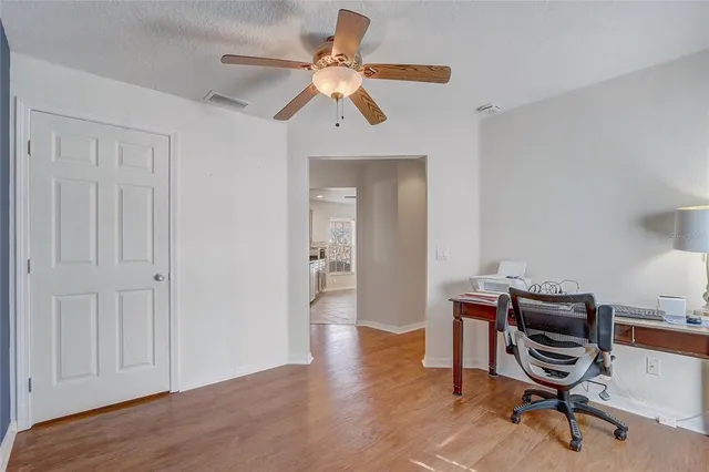 a view of a workspace with furniture and a bathroom