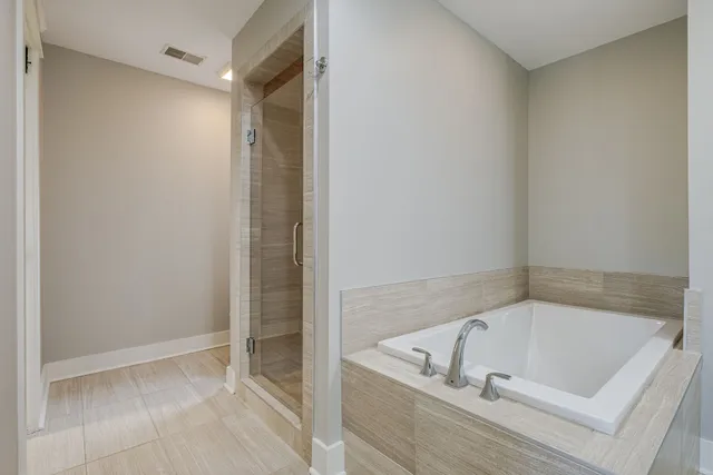 a bathroom with a tub and shower
