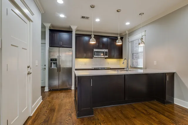 a kitchen with a refrigerator and a sink