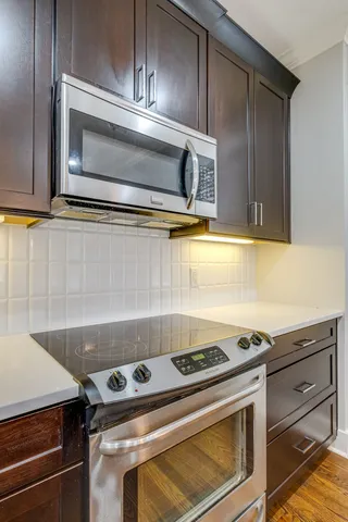 a stove top oven sitting inside of a kitchen