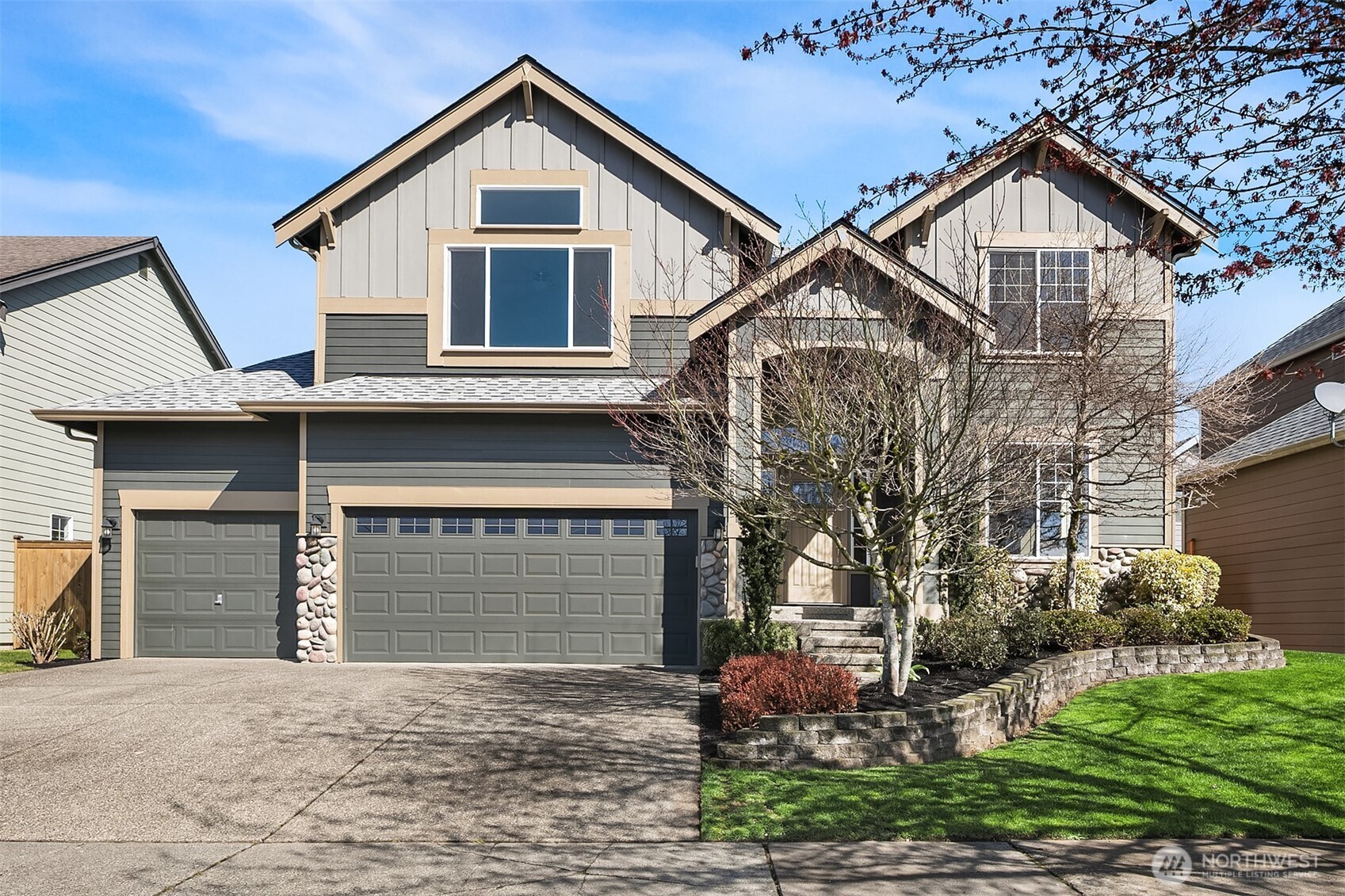 a front view of a house with a yard and garage