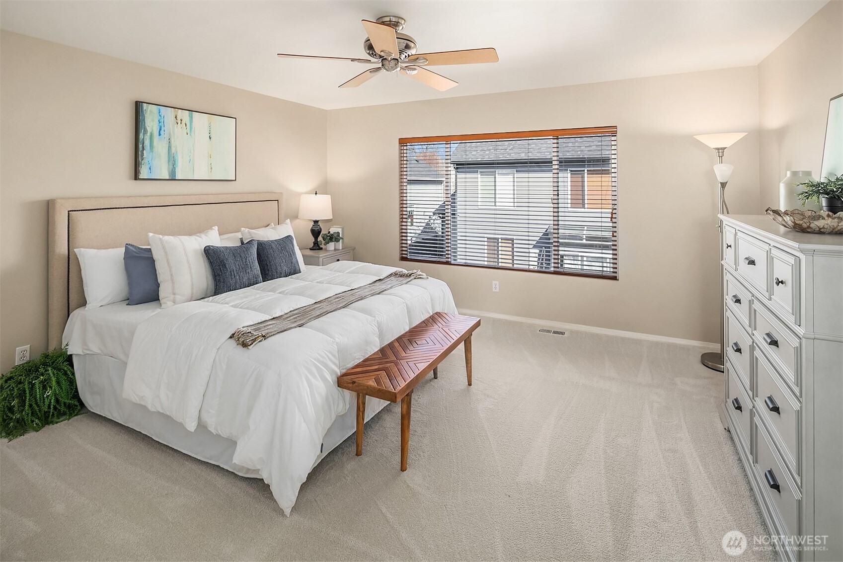 22632 Southeast 281st Street Maple Valley, WA 98038 - Photo 17 of 24 a spacious bedroom with a bed a couch and large window