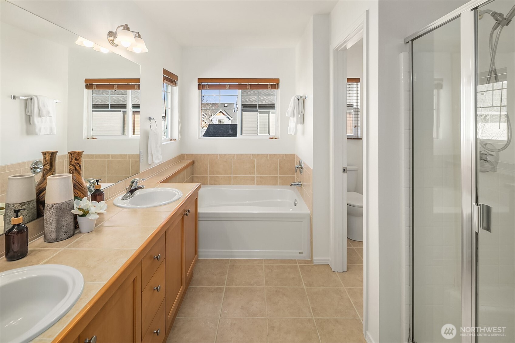 22632 Southeast 281st Street Maple Valley, WA 98038 - Photo 18 of 24 a bathroom with a tub sink and mirror