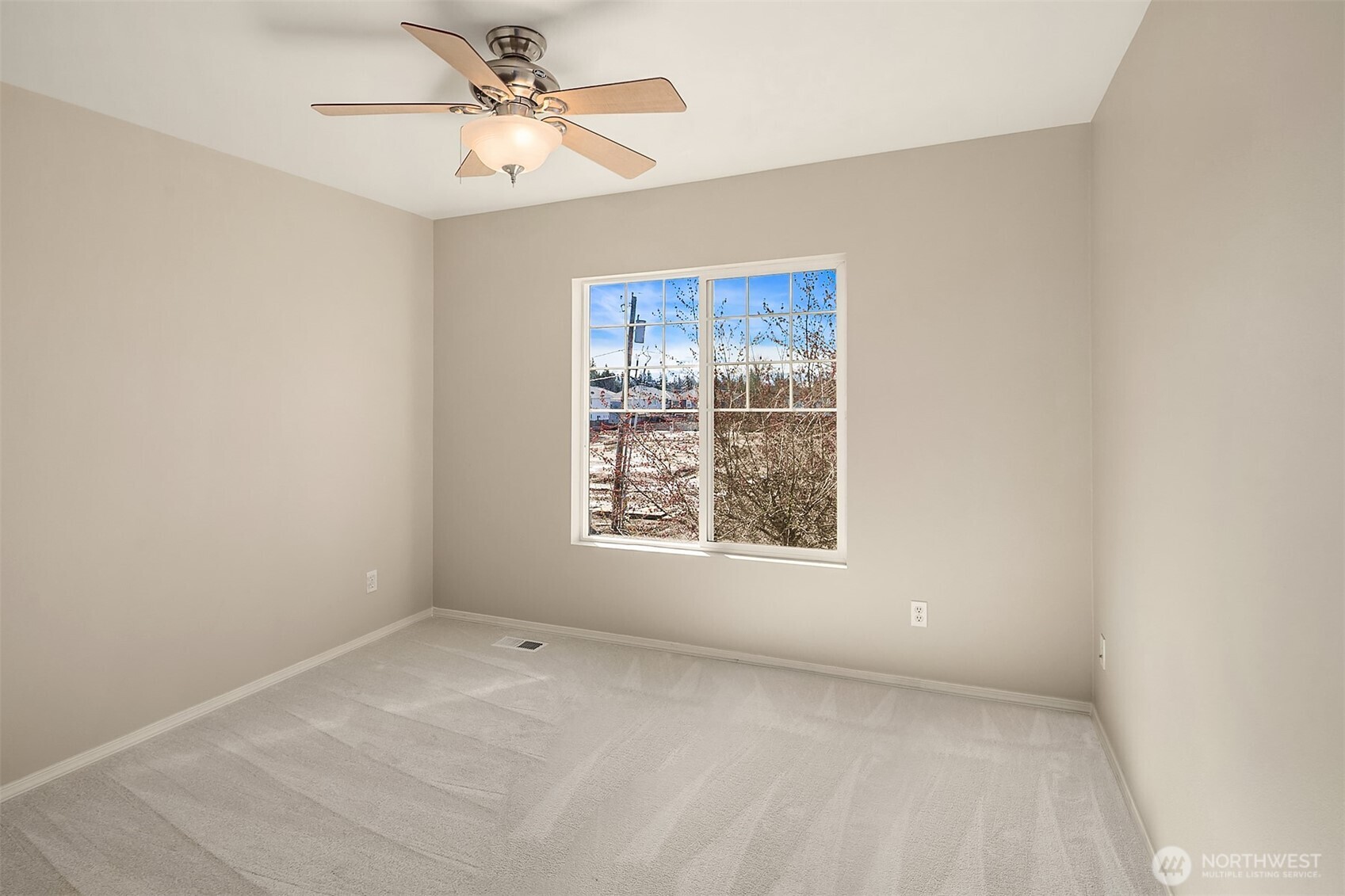 22632 Southeast 281st Street Maple Valley, WA 98038 - Photo 20 of 24 an empty room with a window and a fan
