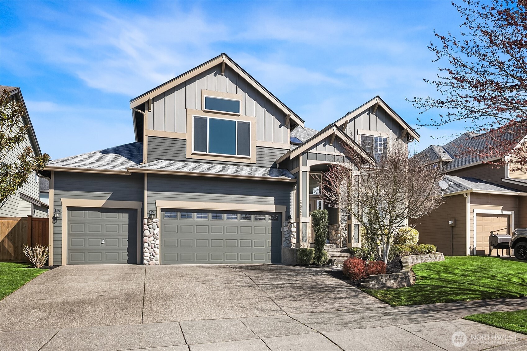 22632 Southeast 281st Street Maple Valley, WA 98038 - Photo 2 of 24 a front view of a house with a yard and garage