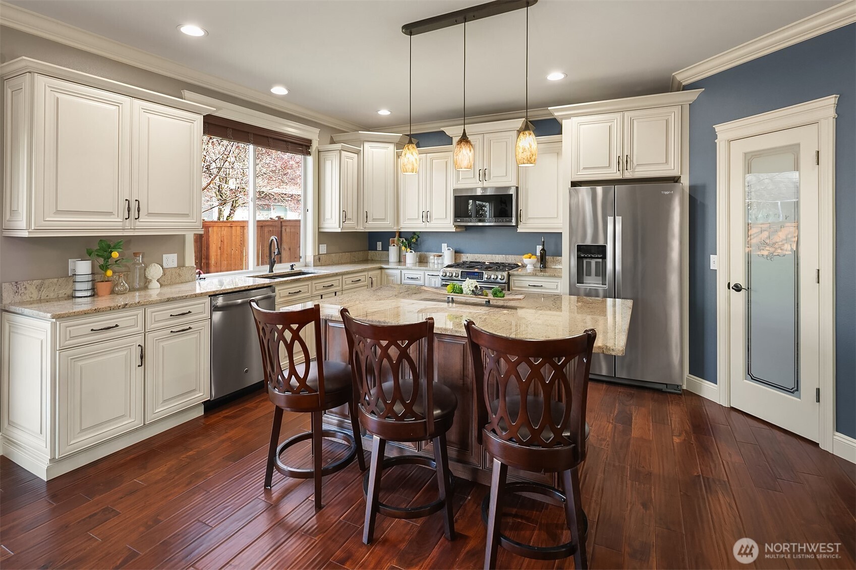 22632 Southeast 281st Street Maple Valley, WA 98038 - Photo 6 of 24 a kitchen with refrigerator a sink and chairs