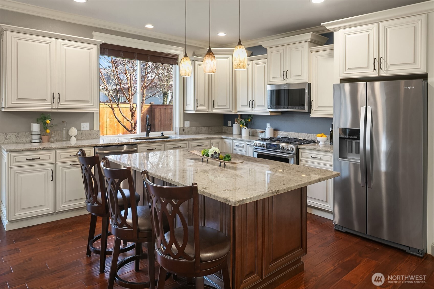 22632 Southeast 281st Street Maple Valley, WA 98038 - Photo 9 of 24 a kitchen with stainless steel appliances granite countertop a table chairs sink refrigerator and microwave