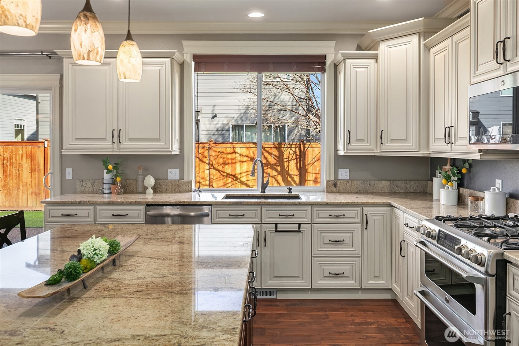 22632 Southeast 281st Street Maple Valley, WA 98038 - Photo 10 of 24 a kitchen with granite countertop white cabinets and white appliances