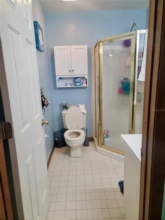 a bathroom with a toilet and a shower