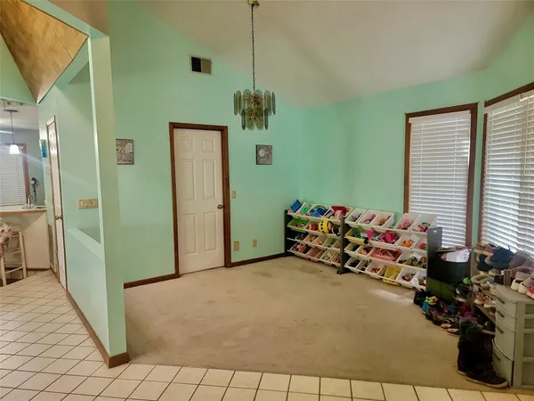 a hallway with toys and a chandelier