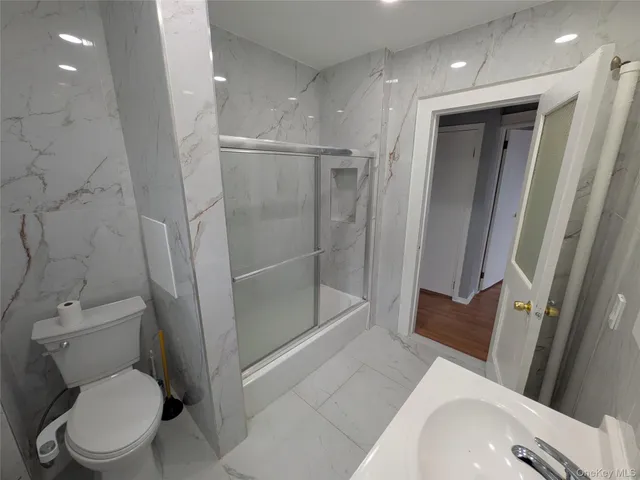 a bathroom with a toilet and a shower