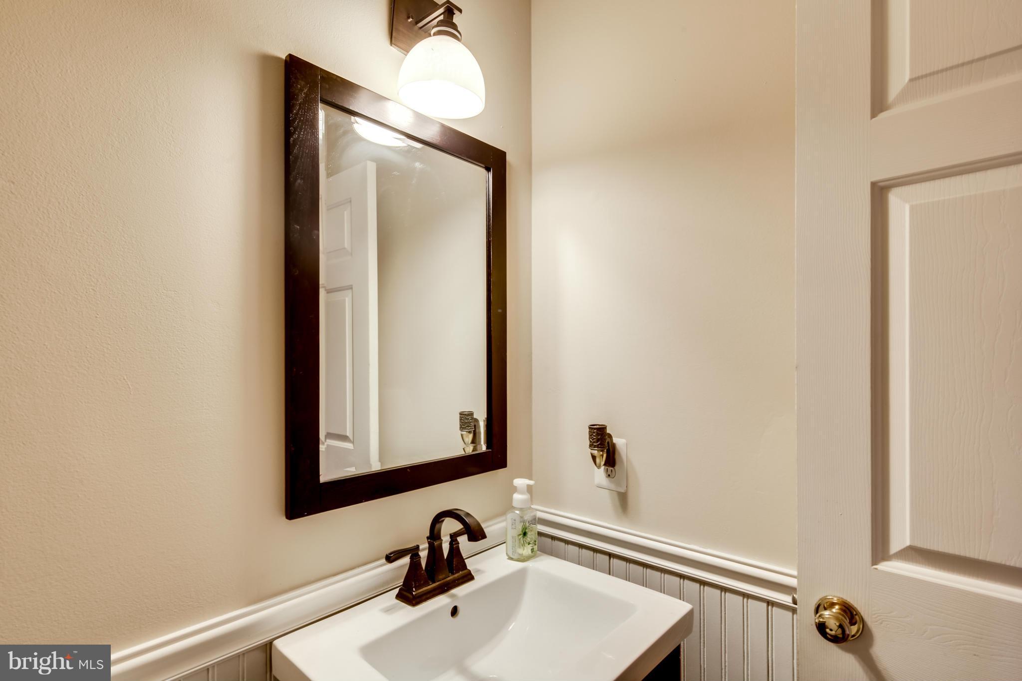 9539 Ridgeview Drive Columbia, MD 21046 - Photo 13 of 30 a bathroom with a sink and a mirror