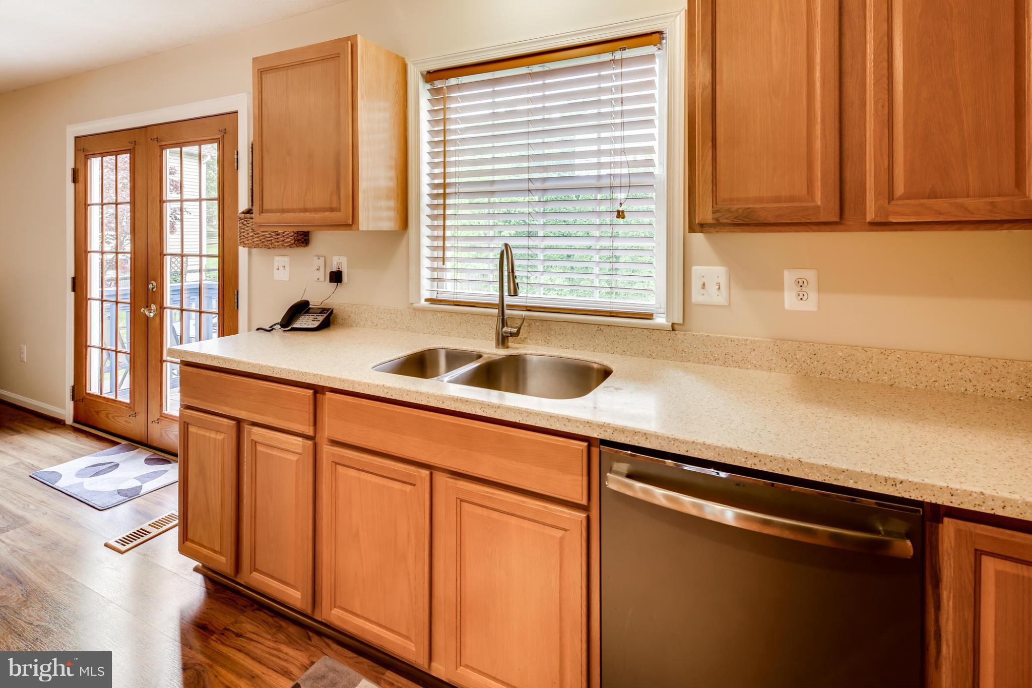 9539 Ridgeview Drive Columbia, MD 21046 - Photo 5 of 30 a kitchen with stainless steel appliances white cabinets a sink and a window