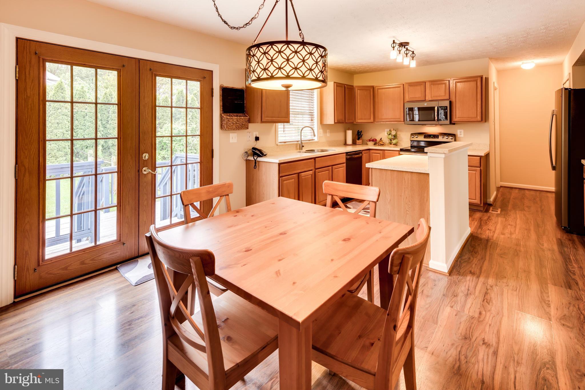 9539 Ridgeview Drive Columbia, MD 21046 - Photo 6 of 30 a view of a dining room with furniture window and wooden floor