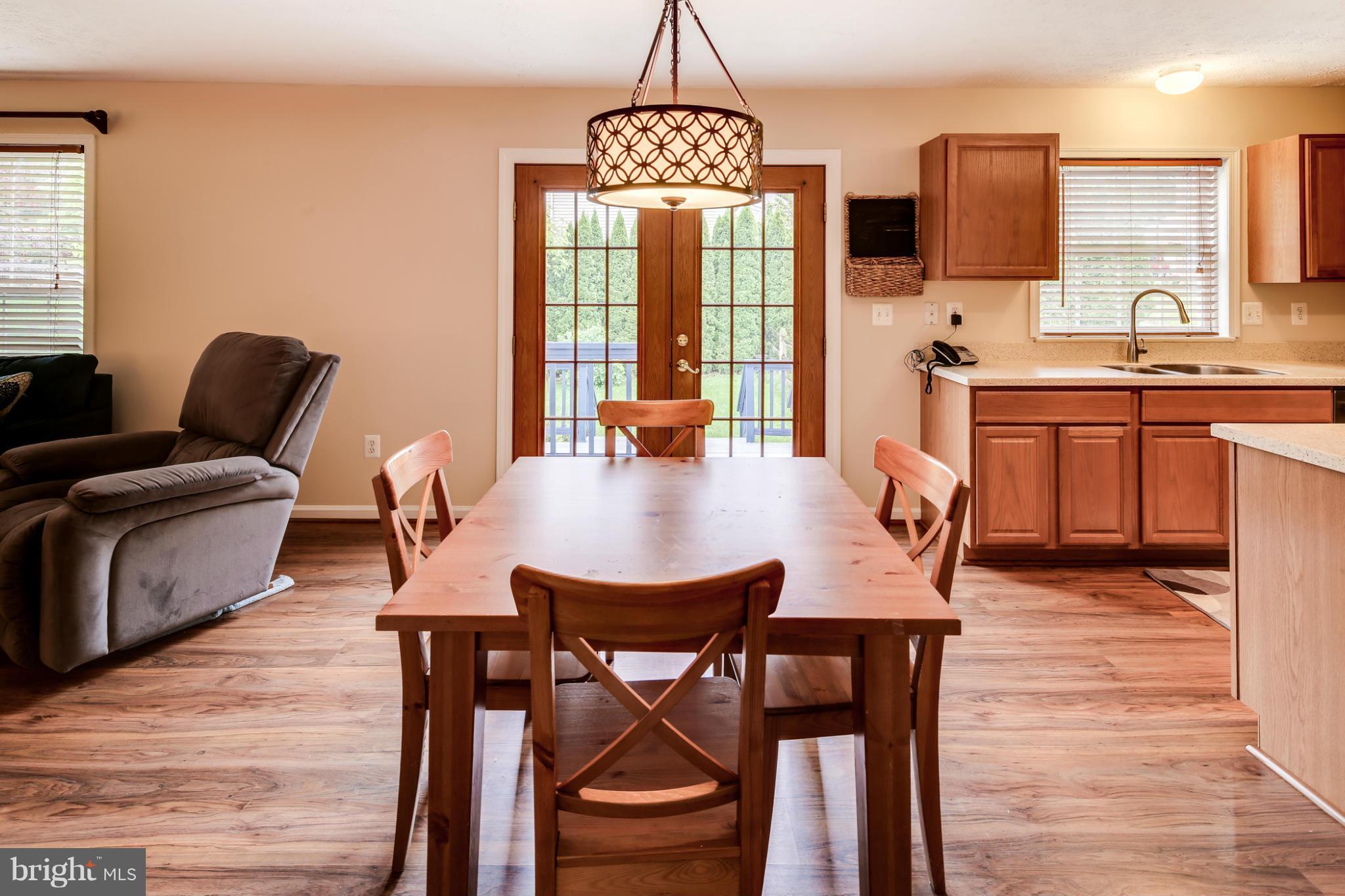 9539 Ridgeview Drive Columbia, MD 21046 - Photo 8 of 30 a view of a dining room with furniture window and wooden floor