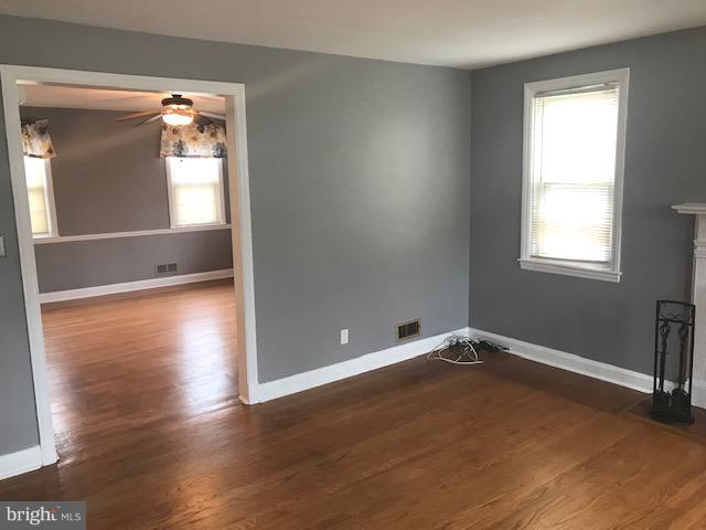 1001 Harwall Road Baltimore, MD 21207 - Photo 50 of 109 an empty room with wooden floor and windows