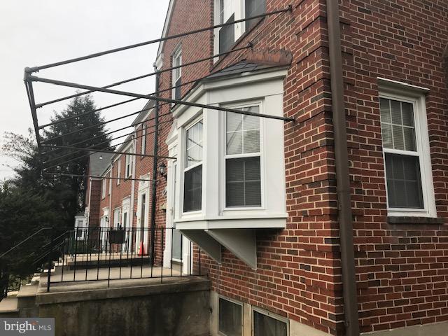 1001 Harwall Road Baltimore, MD 21207 - Photo 6 of 109 a view of a brick house with a street