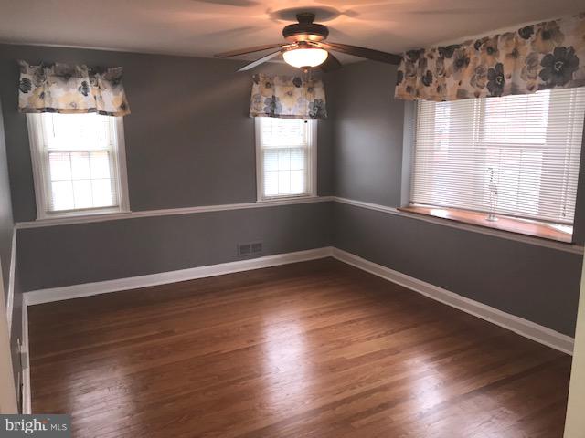 1001 Harwall Road Baltimore, MD 21207 - Photo 52 of 109 a view of an empty room with wooden floor and a window